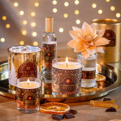 Candle and bottle set on a tray with decorative lights in the background