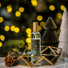 Bottle of Absinth on a decorative stand with festive lights and trees in the background