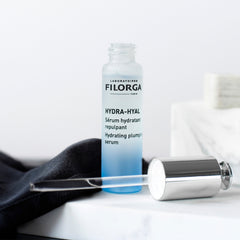 Filorga Hydra-Hyal serum bottle with applicator on a white background