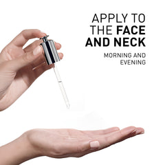 Hand holding a dropper with a small amount of liquid over an open palm, against a white background.