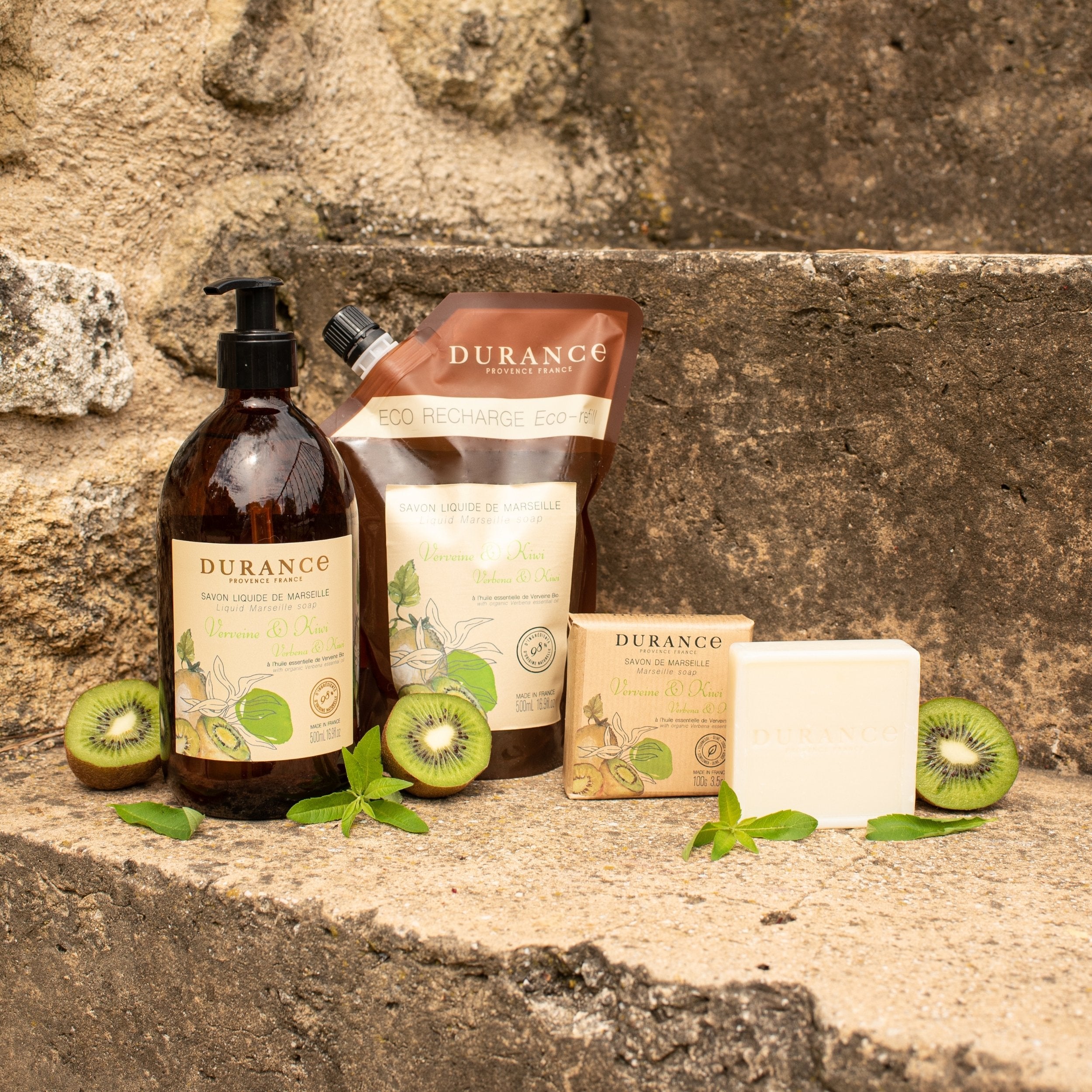 Durance skincare products with kiwi slices on a stone surface