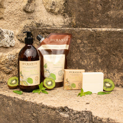 Durance skincare products with kiwi slices on a stone surface