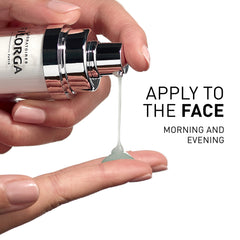 Hand holding a skincare bottle with product being applied to the palm, text 'APPLY TO THE FACE MORNING AND EVENING' on a white background.