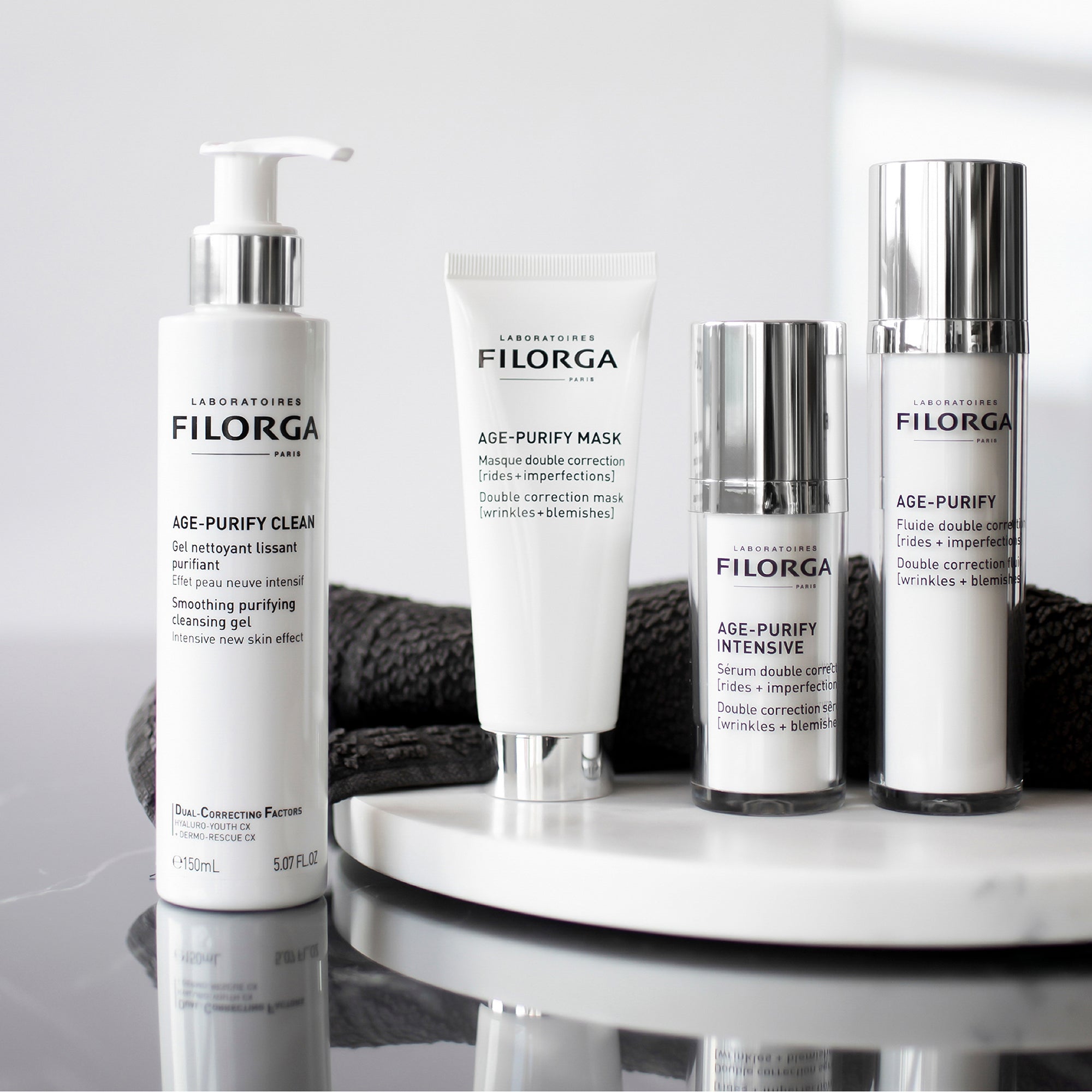 Filorga skincare products on a white surface with a gray background