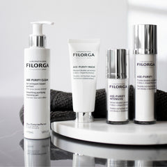 Filorga skincare products on a white surface with a gray background