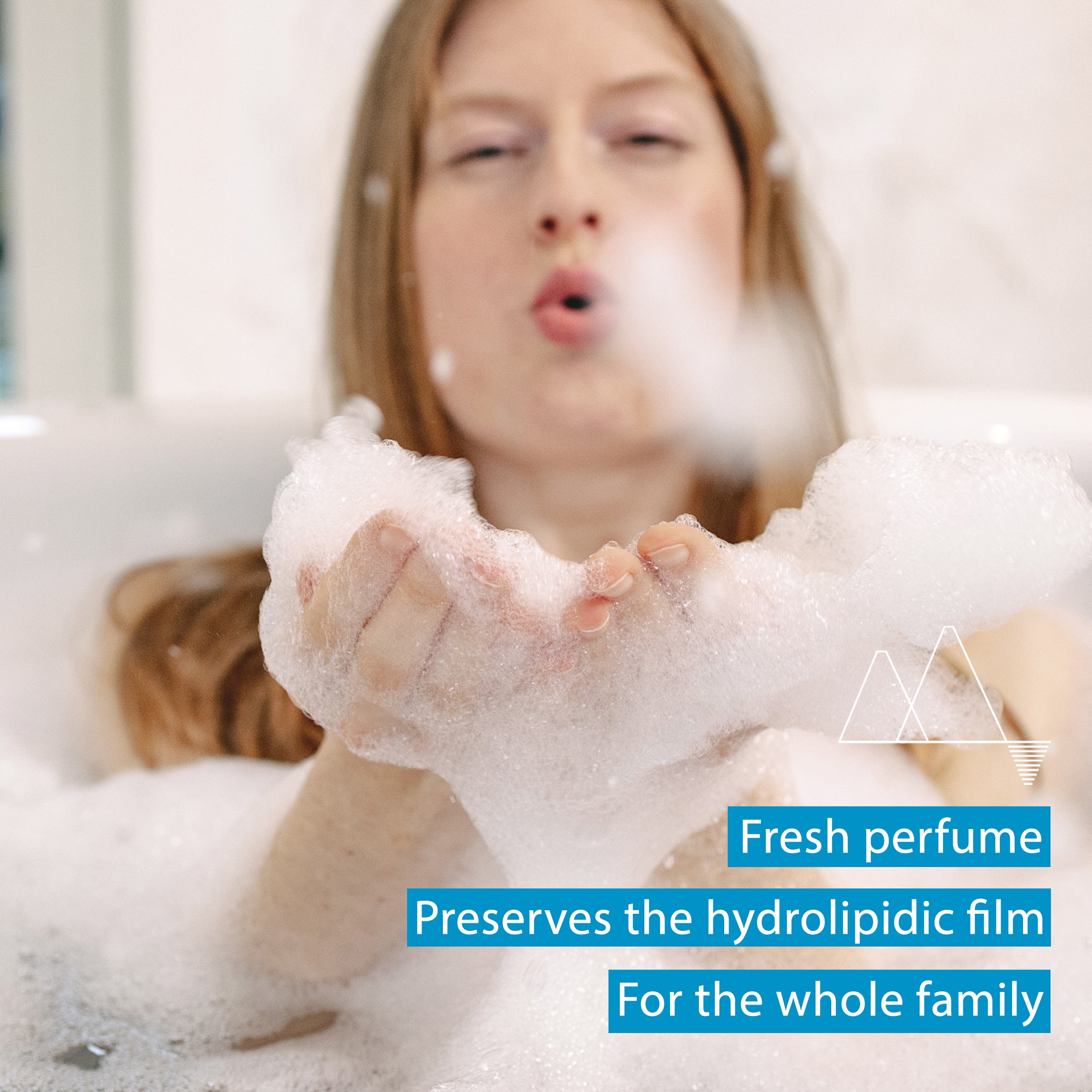 Person blowing bubbles with a focus on the soap foam, text about fresh perfume and hydrophilic film.