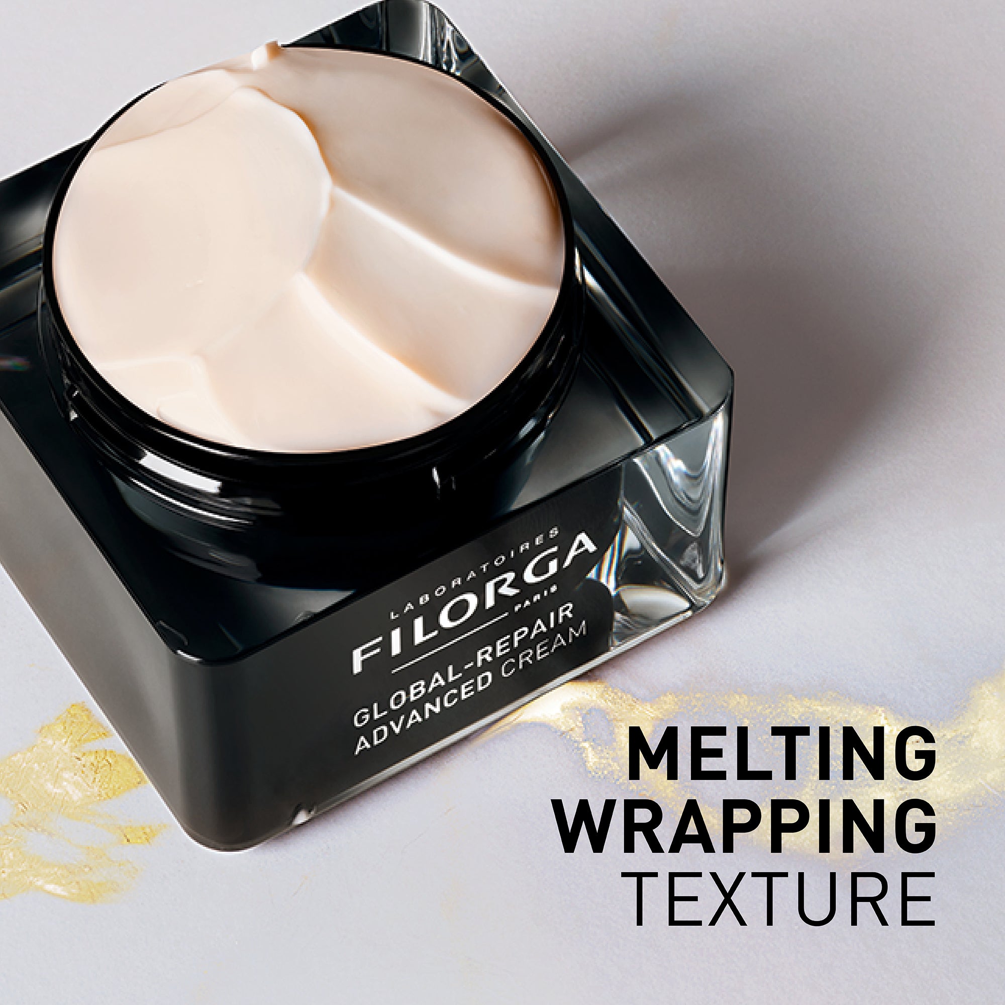 Filorga Global Repair Advanced Cream jar with melting cream on a light background