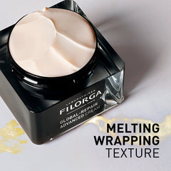 Filorga Global Repair Advanced Cream jar with melting cream on a light background