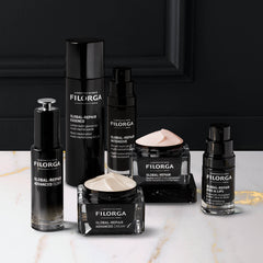 Filorga skincare products on a marble surface with a black background