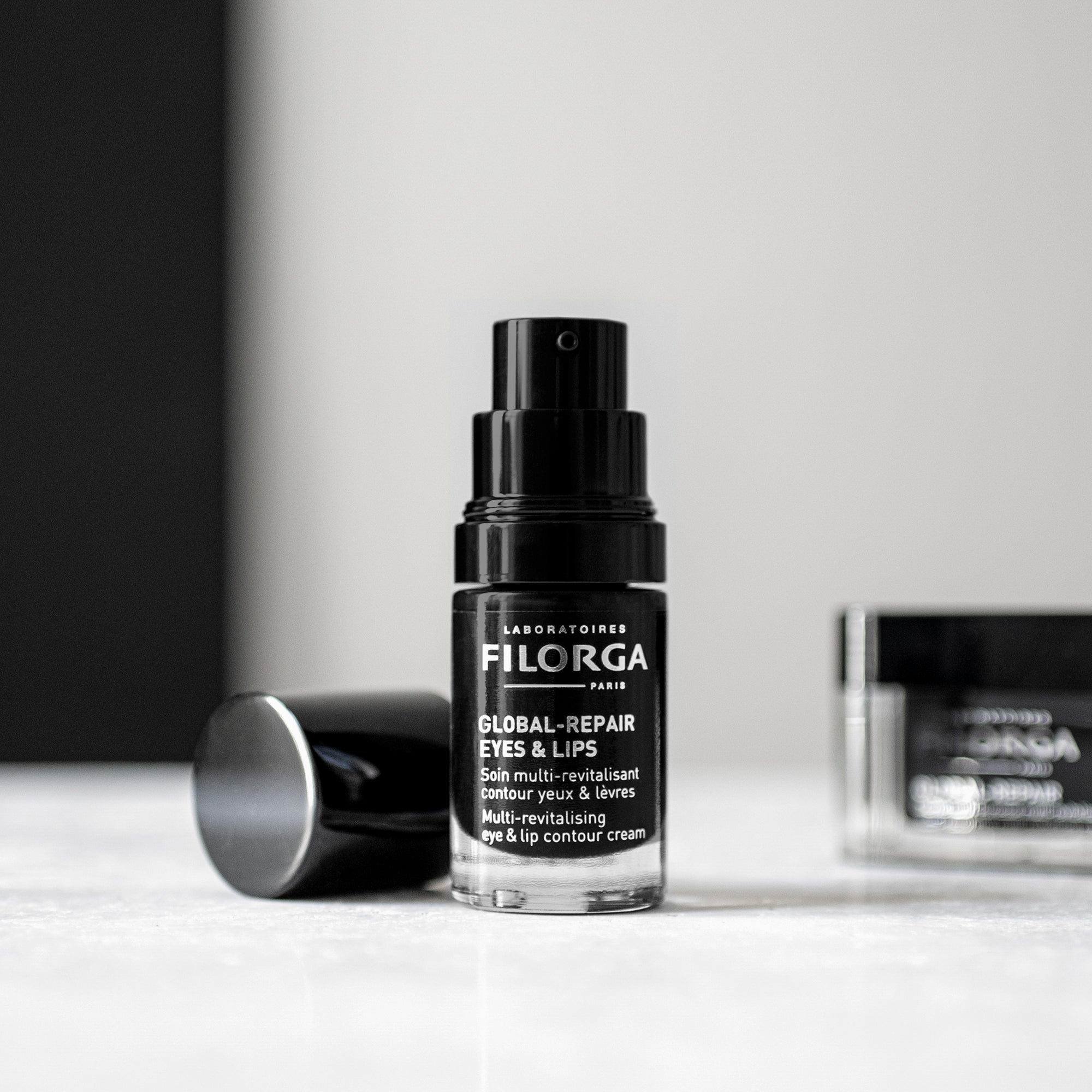Filorga skincare bottle on a white surface with a neutral background