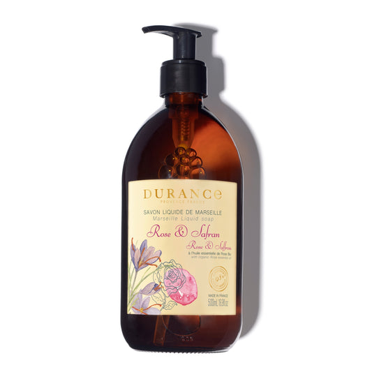 Brown bottle with pump and floral label on a white background
