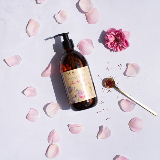 Bottle of Durane soap with floral design on a light background with pink petals