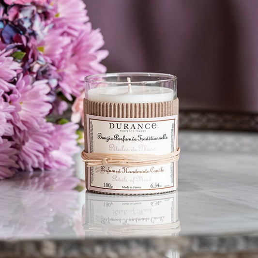Durance candle with floral arrangement in the background