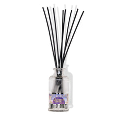 Reed diffuser with black sticks in a clear bottle on a white background