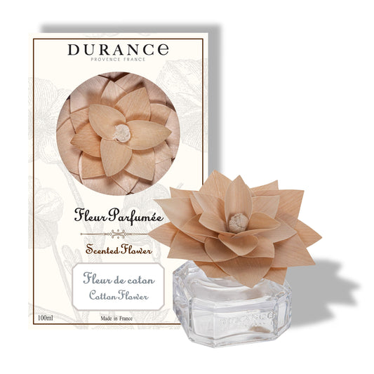 Durance scented flower in a clear container with packaging on a white background