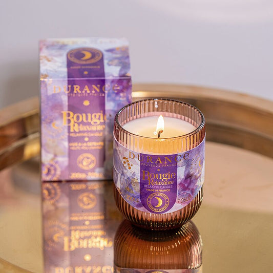 Durance candle with packaging on a reflective surface
