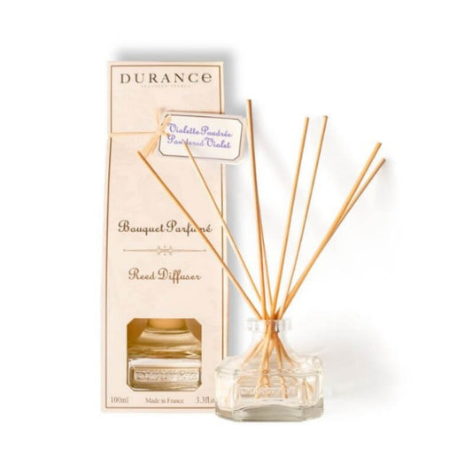 Reed diffuser with packaging on a white background